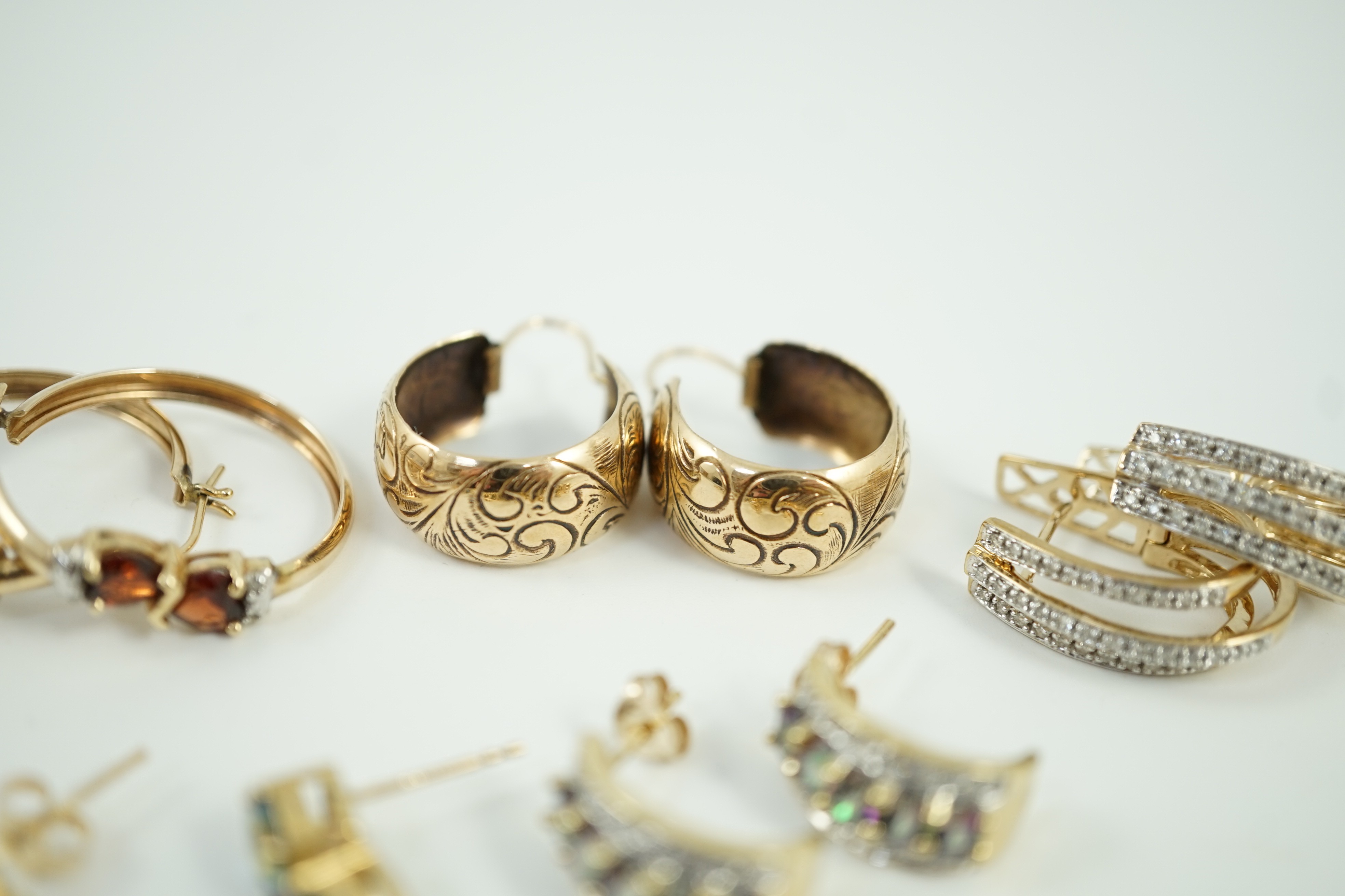 Four assorted modern pairs of 9ct gold and gem set earrings and one pair of yellow metal earrings, gross weight, 23.2 grams.